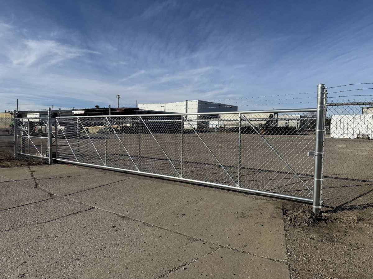 Commercial sliding chain link gate at an industrial site