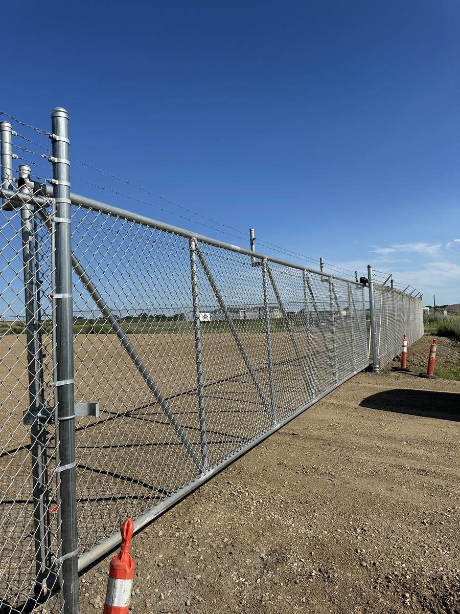 Tall industrial chain link security gate